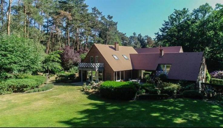 a large house in a yard with trees and grass at Silk and Stone Manor in Grez-Doiceau