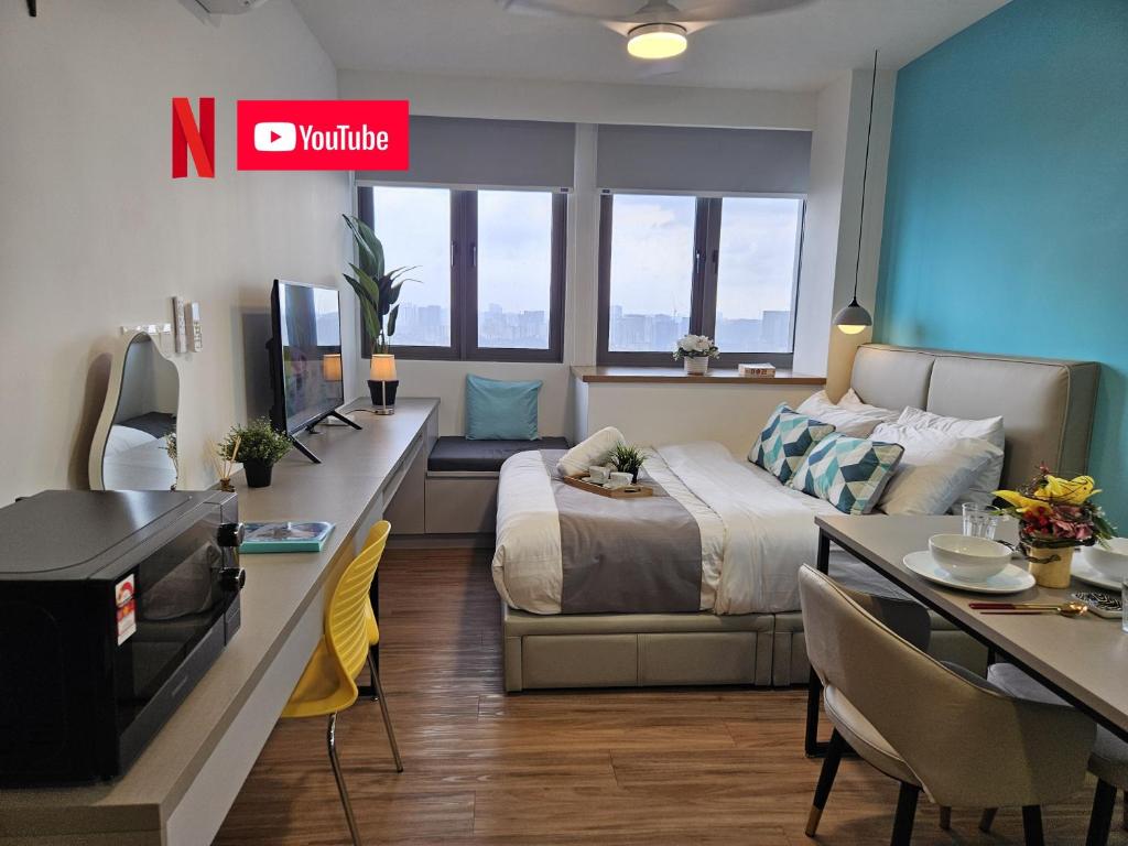 a hotel room with a bed and a dining table at SerenityStayatRiveria KL Sentral in Kuala Lumpur