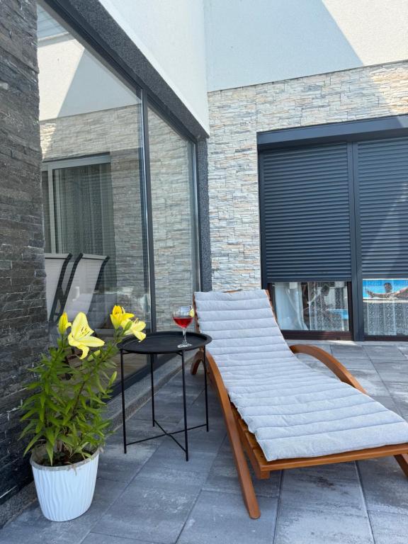 a bench and a table on a patio at White house Paradise in Bihać