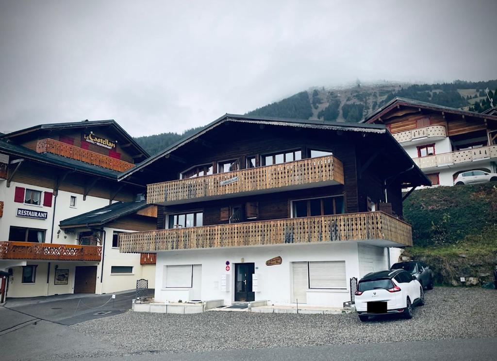 a white car parked in front of a building at Appartement EDELWEISS in Châtel
