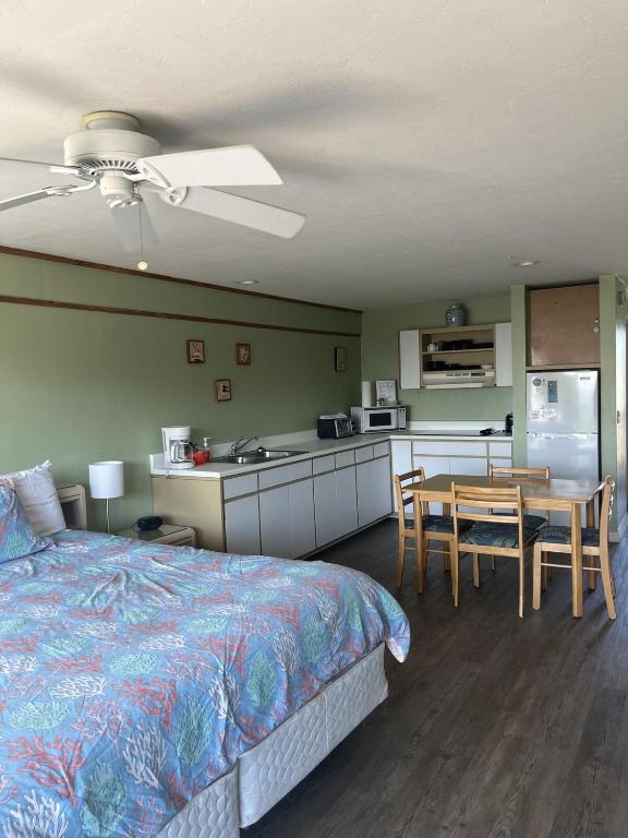 a bedroom with a bed and a table and a kitchen at Unit 225 Beautiful Cedar key in Cedar Key