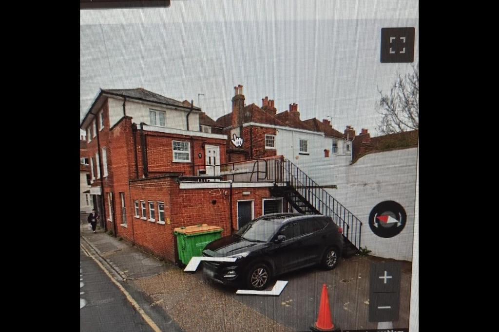 a black car parked in front of a building at Dunstans Retreat in Canterbury
