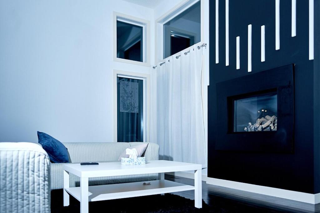 a living room with a white couch and a table at Evanston House in Calgary