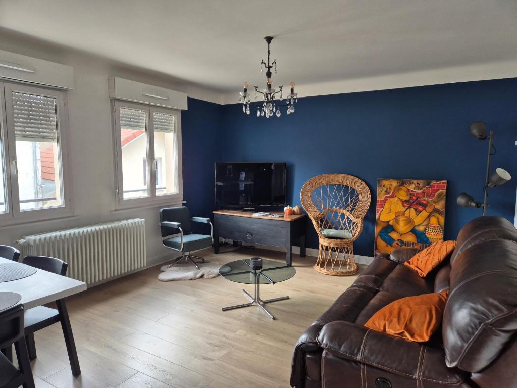 a living room with a couch and a table at APPT LUMINEUX F3 QUARTIER CALME in Vichy