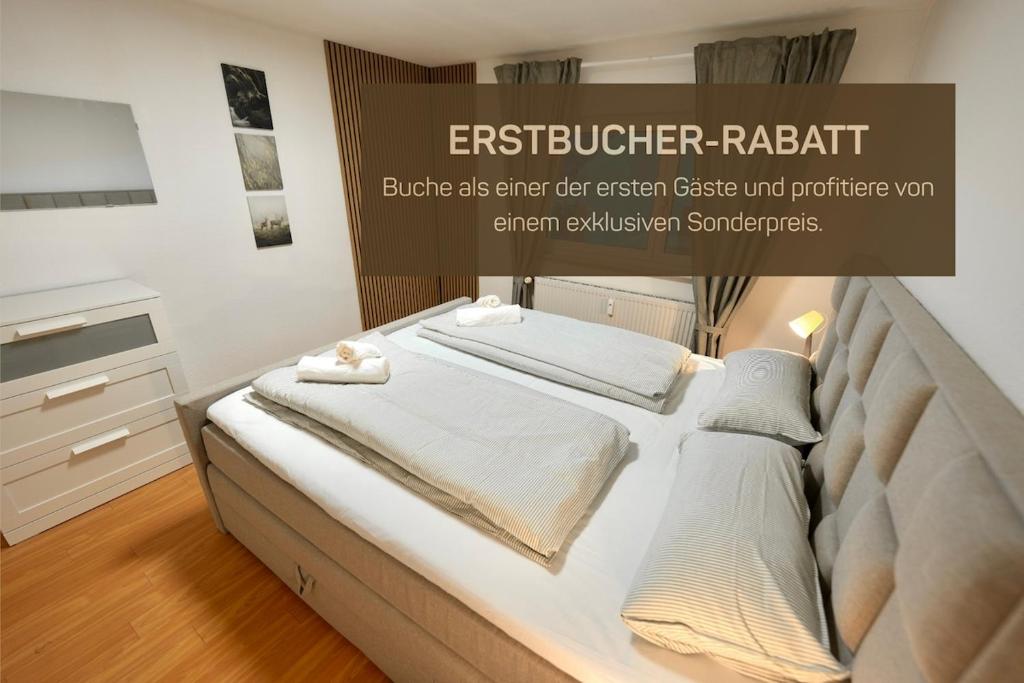 a bedroom with a large bed with white sheets at Ferienwohnung Paula in Sankt Georgen im Schwarzwald