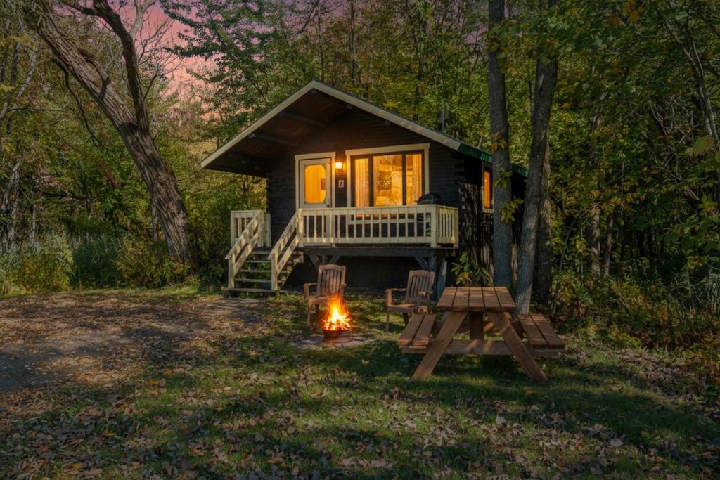 a tiny house in the woods with a camp fire at Domaine de l Archipel in Sorel