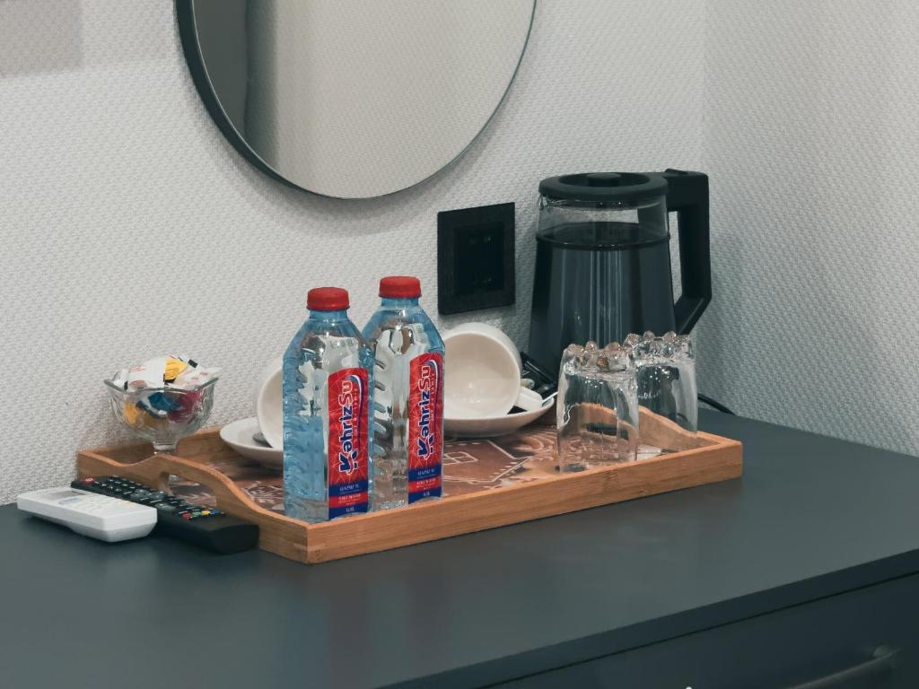 - un plateau avec des bouteilles d'eau et des verres sur un comptoir dans l'établissement Onze Boutique Hotel Baku, à Baku