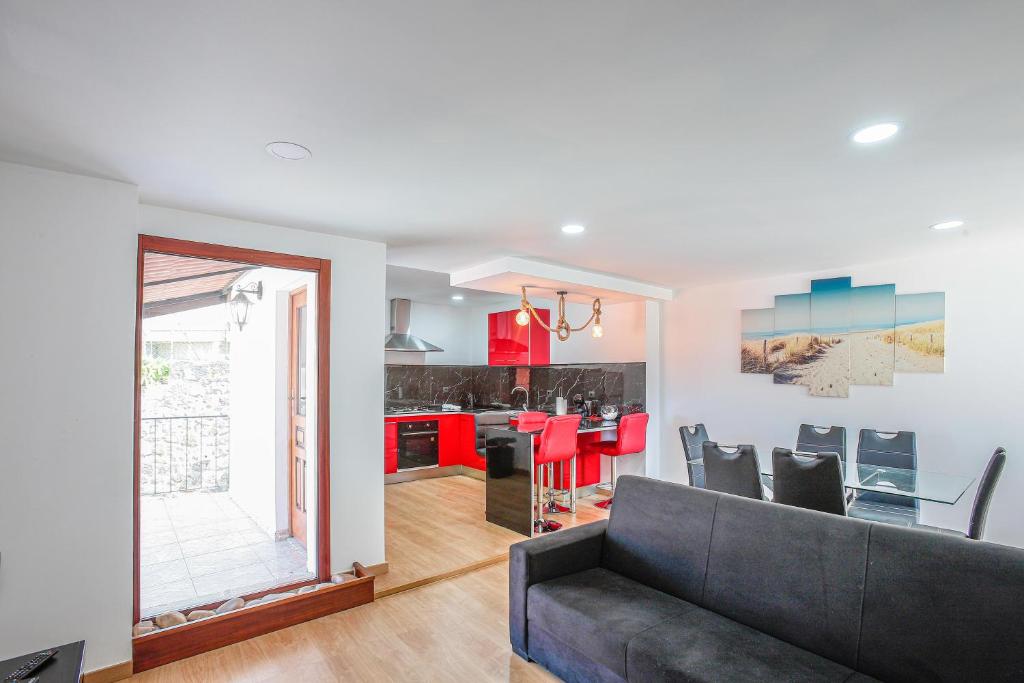 a living room with a couch and a kitchen at Mirando Espanha in Melgaço