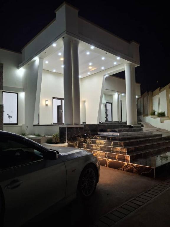 a car parked in front of a building at night at Mbuya Express Inn in Manzini