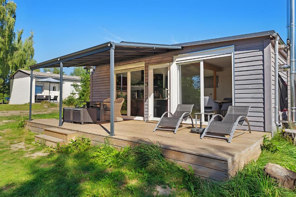 a house with a deck with chairs on it at Ferienhaus 110 in Stelzendorf