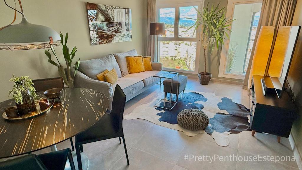 a living room with a couch and a table at #PrettyPenthouseEstepona in Estepona
