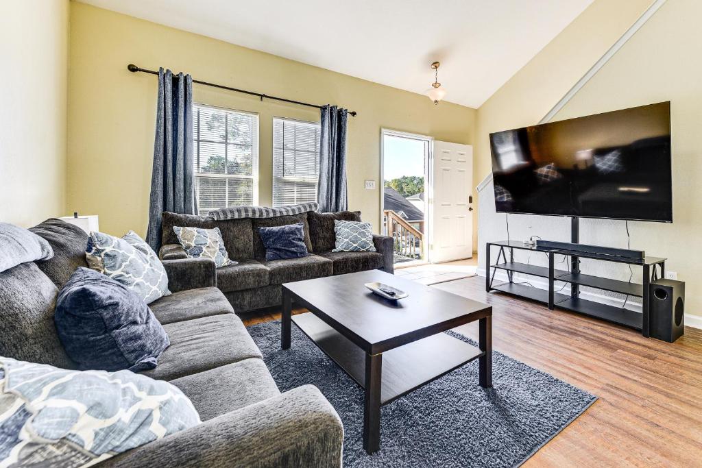 a living room with a couch and a flat screen tv at 4 Mi to FSU Pet-Friendly Townhome in Zion Hill