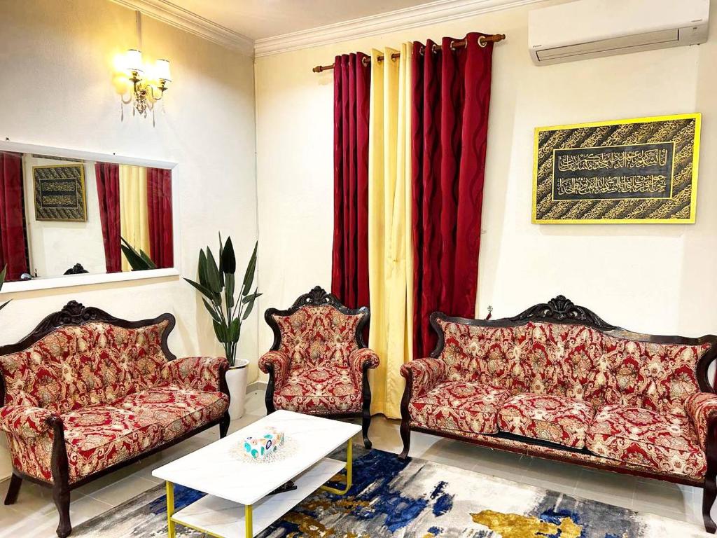 a living room with two couches and a table at Wan Z Homestay Pasir Mas in Pasir Mas