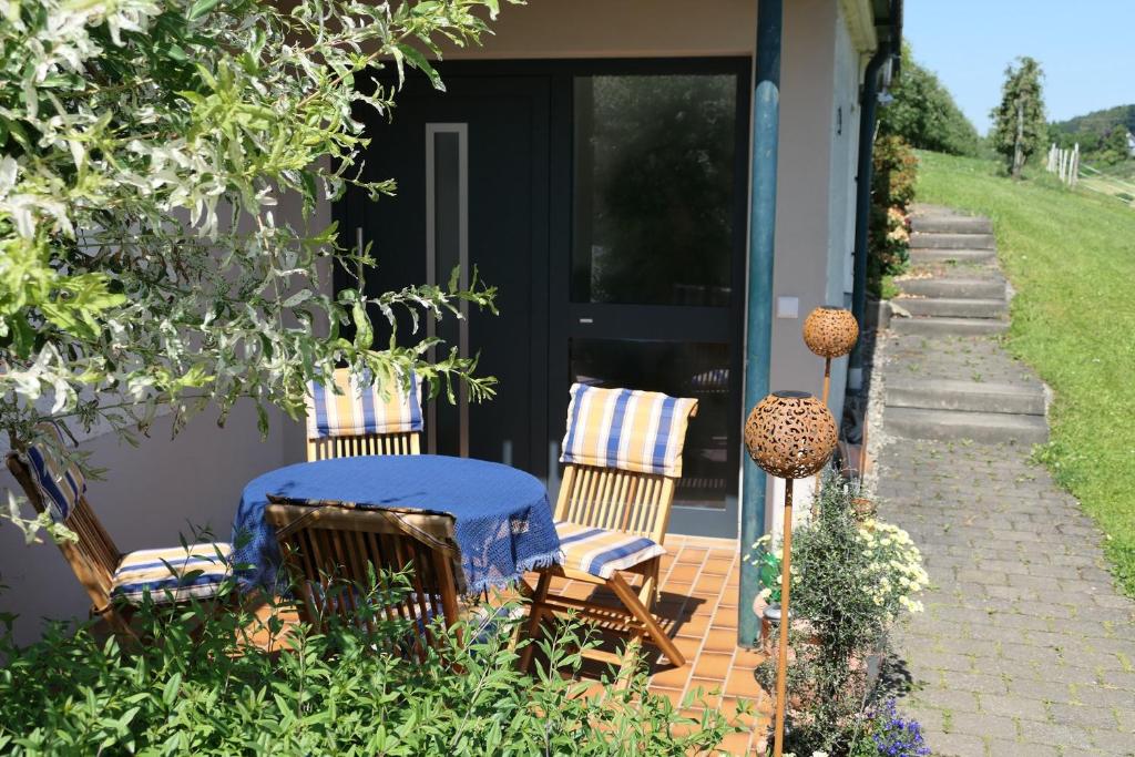 a house with two chairs and a table on a patio at Haus Kathan in Bechtersweiler