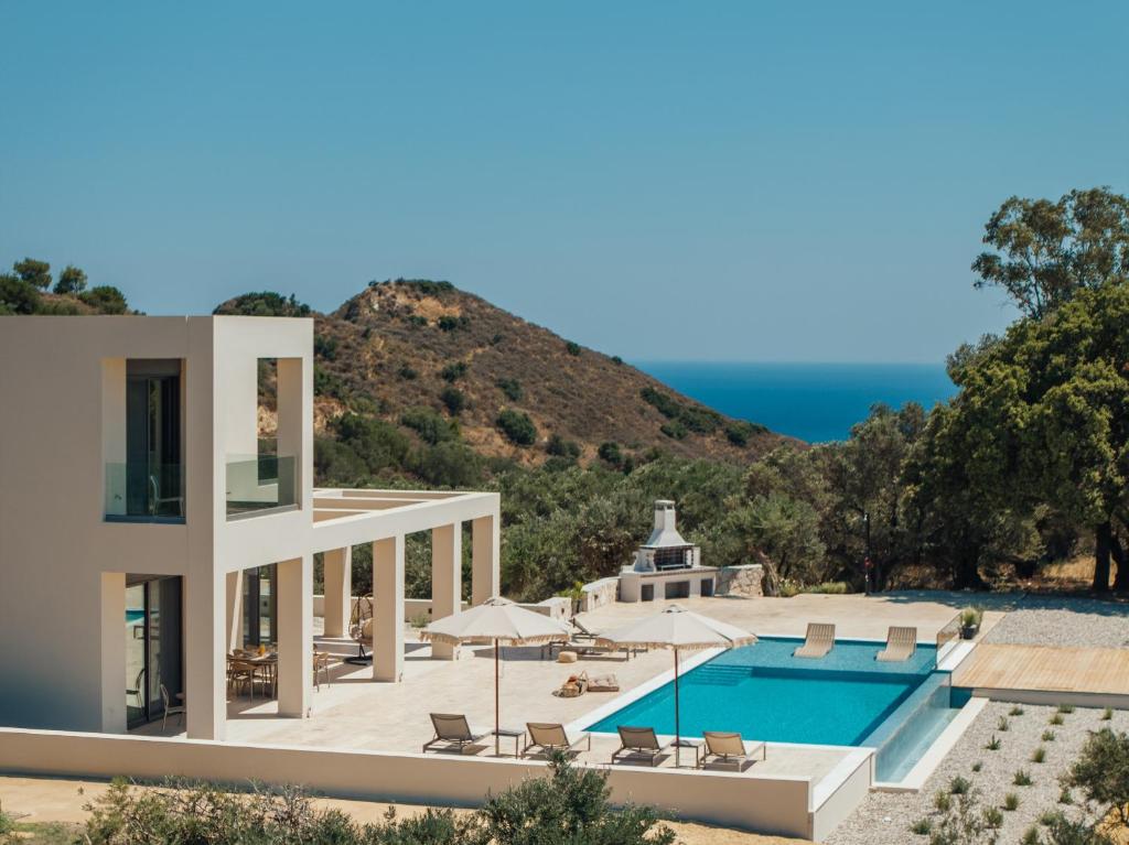a villa with a swimming pool and the ocean at Euphoria Hill Villa, By TK Property Management in Kalamaki