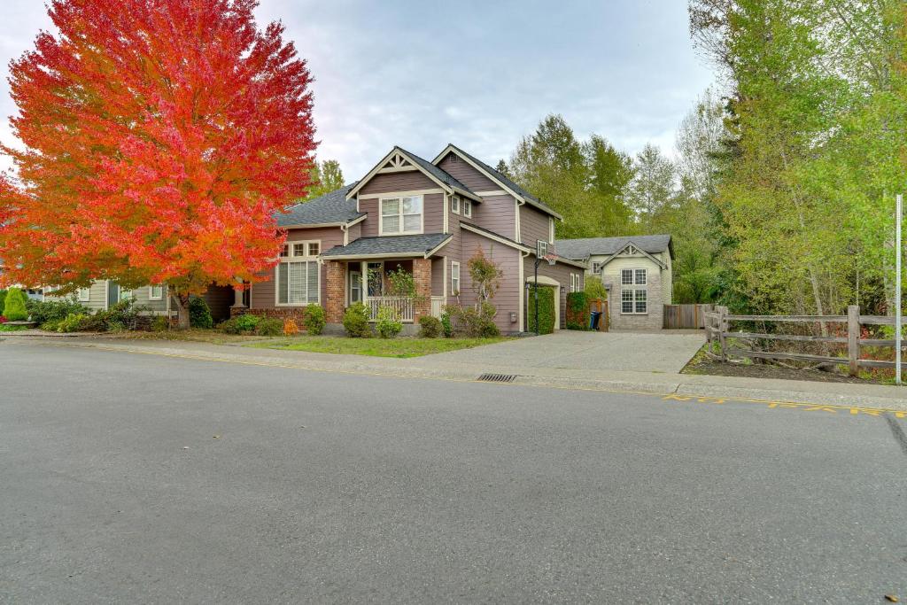 a house with a red tree in front of a street at 6 Mi to Microsoft HQ! Remote Work Retreat in Redmond