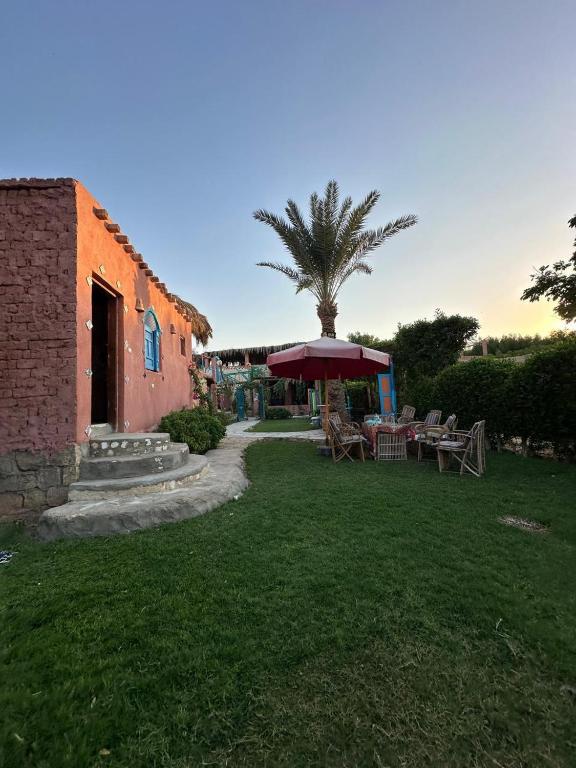 a patio with a table and an umbrella in a yard at Roof Tunis in Tunis