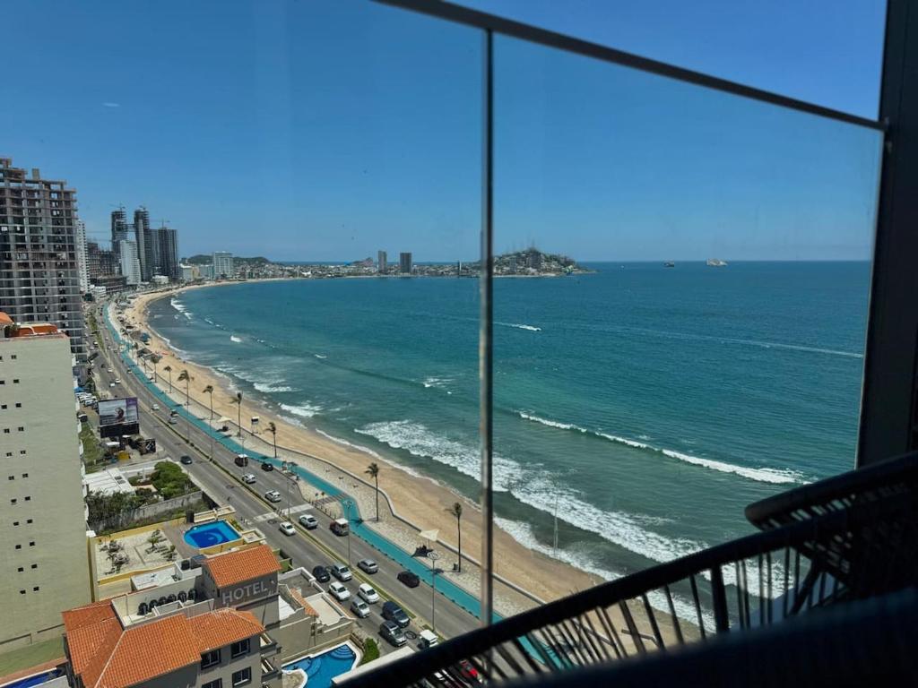 a view of a beach and the ocean from a building at Habitacion Frente al Malecon By Partner Host in Mazatlán