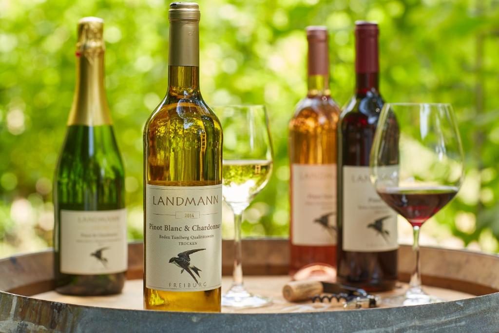 a group of wine bottles and glasses on a table at Weingut Landmann Ferienwohnungen in Freiburg im Breisgau