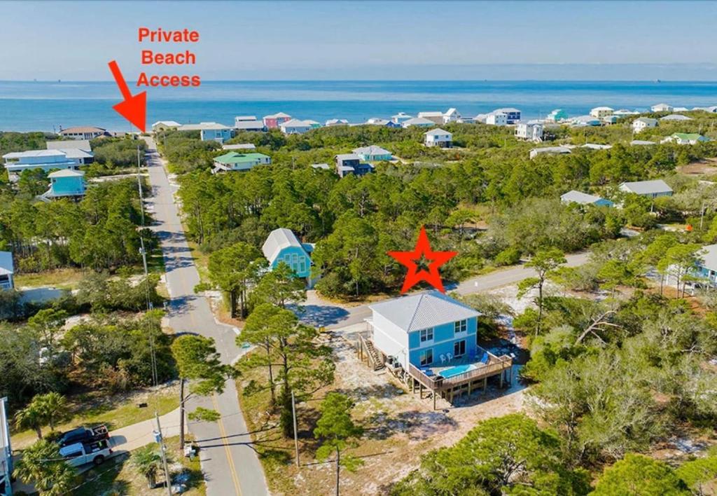 an aerial view of a beach house with a star on the roof at Private Beach and Pool in Gulf Shores