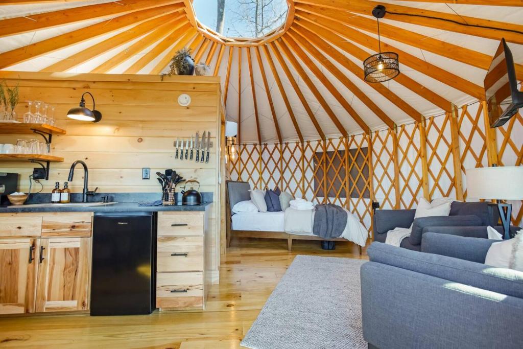 a kitchen and a living room in a yurt at Adventure Abode - Modern Yurt in Brookville