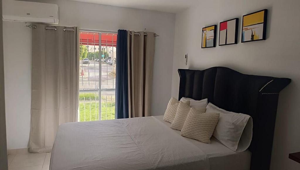a bedroom with a bed with white sheets and a window at Apartamento palmera del este 3 in La Javilla