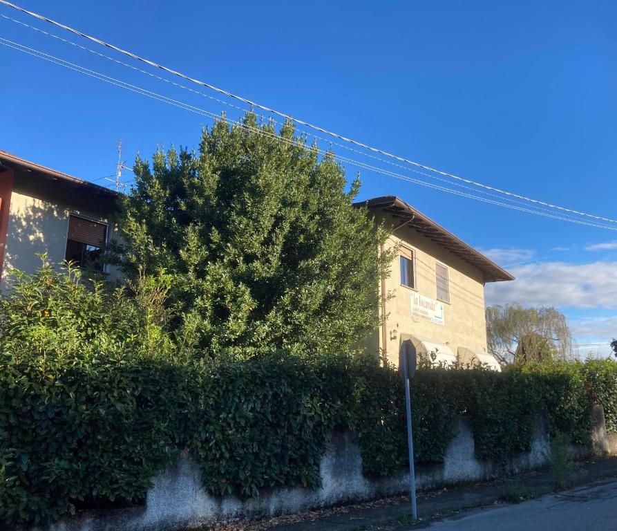 a house with a hedge in front of a building at La Locanda Di Perico Paola in Veruno
