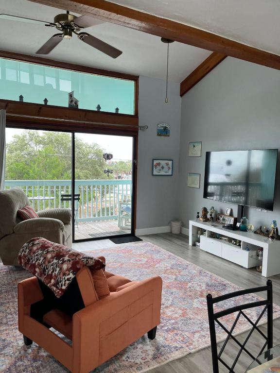 a living room with a couch and a tv at Sunset Vista Condo 328 in Cedar Key