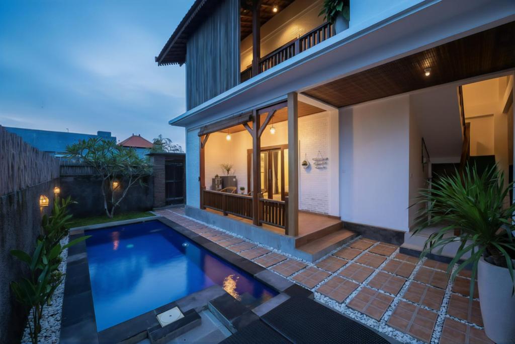 a swimming pool in the backyard of a house at Kubu Daje Villa Canggu 2BR With Private Pool in Dalung