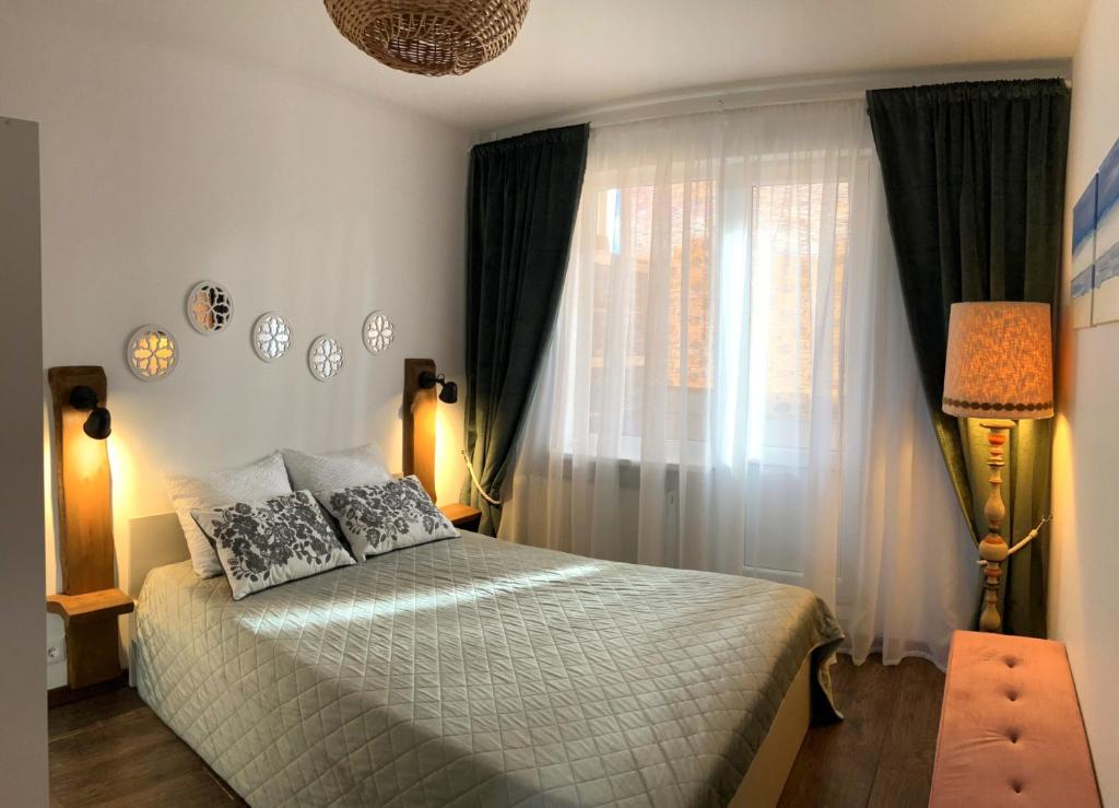 a bedroom with a bed and a window at Li Amber Apartment Carnikava in Carnikava