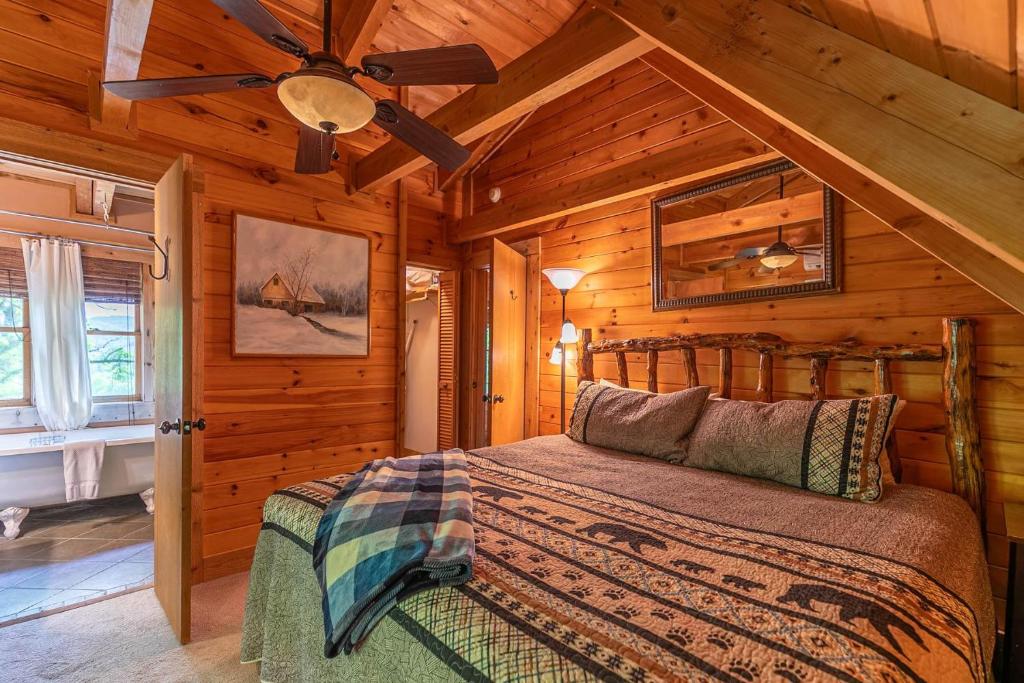 a bedroom with a bed in a wooden cabin at St Johns Ridge in Sugar Grove