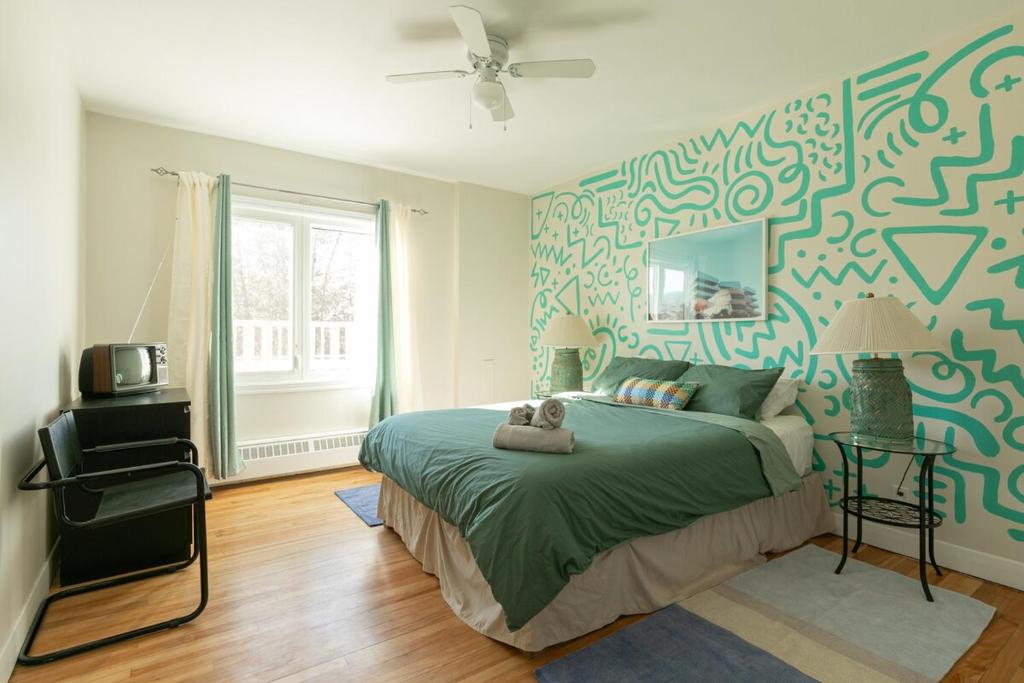 a bedroom with a bed with a teddy bear on it at #Le80ies - Downtown Rooftop - Free shuttle to ski Mountain in Mont-Tremblant