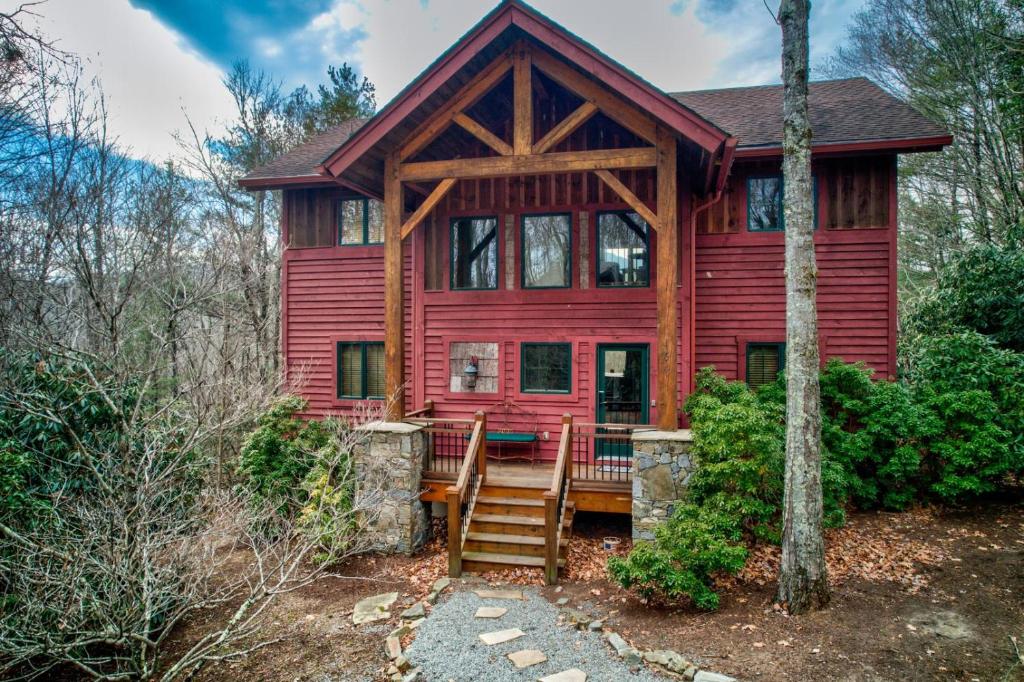 a red house with a staircase in front of it at Muir Lodge in Blowing Rock