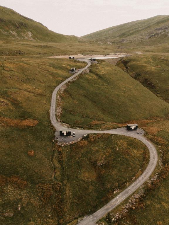 a winding road in the middle of a field at Barlwyd Glamping in Blaenau-Ffestiniog