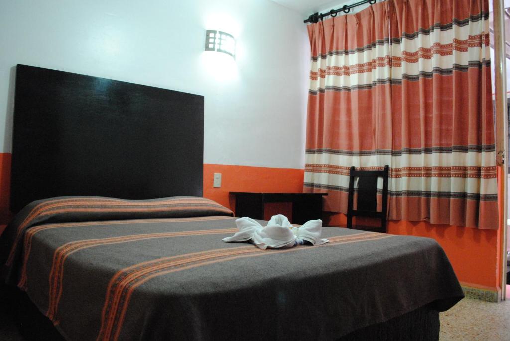 Postel nebo postele na pokoji v ubytování Hotel Jiménez
