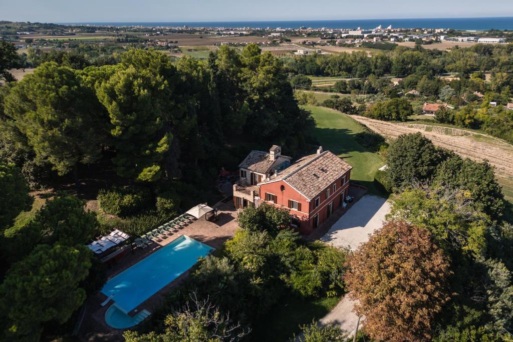 an aerial view of a house with a swimming pool at Villa Adele - Historic Dimora with pool & sea view in Senigallia