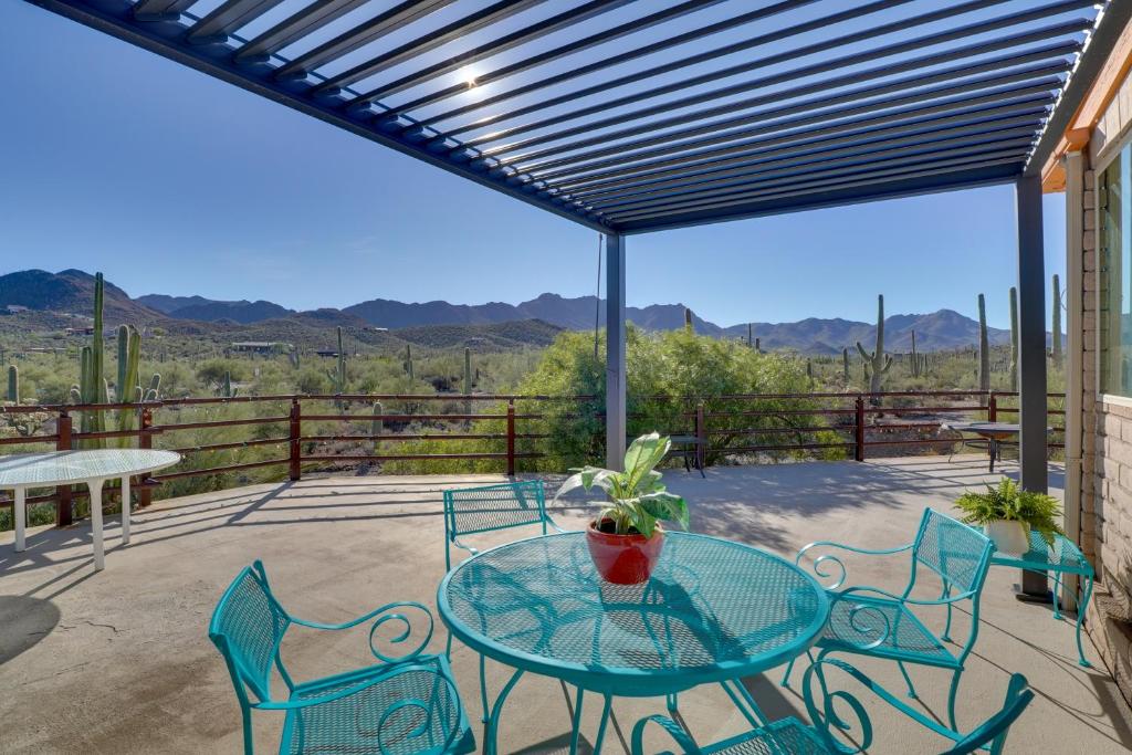 a patio with a glass table and chairs at Pool and Stunning Mtn Views! Eclectic Tucson Home in Tucson