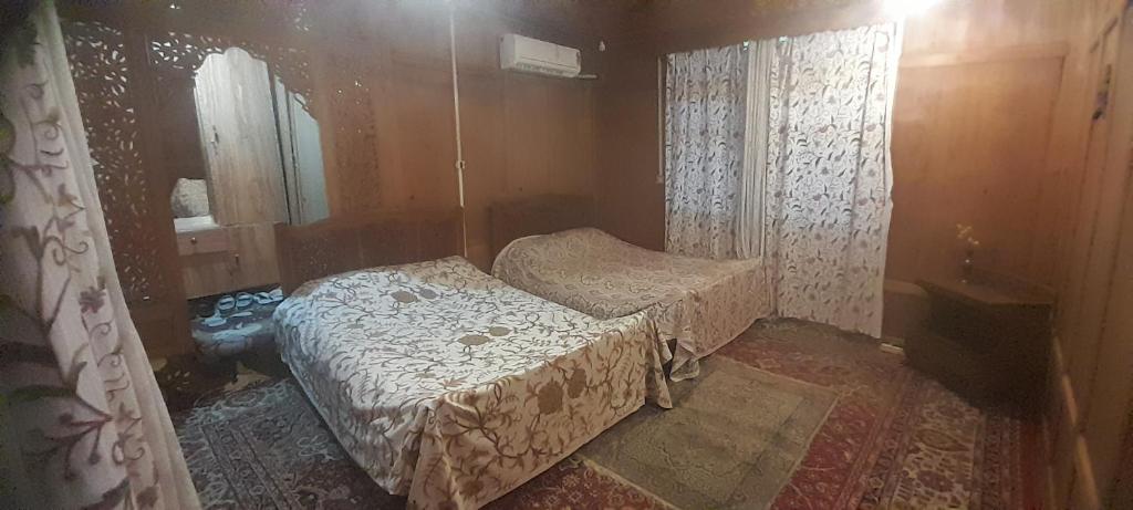 a small room with a bed and a mirror at House boat MASHAL in Srinagar