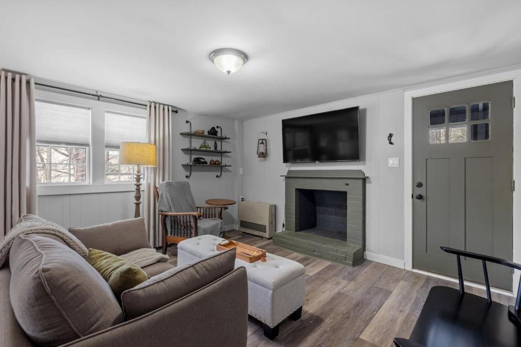 a living room with a couch and a fireplace at Current Cottage Waterside 1 Bed 1 Ba Private Pond in Bradford