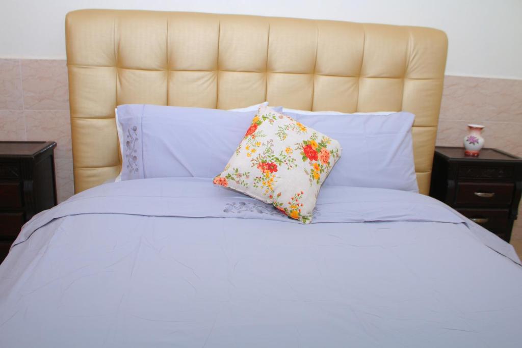 a white bed with two pillows on it at BOUZNIKA Piscine et plage in Bouznika