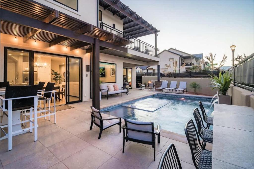 a patio with a pool and chairs and a house at 30-31| 2 Homes in St George with Private Pools and Hot Tubs in Santa Clara