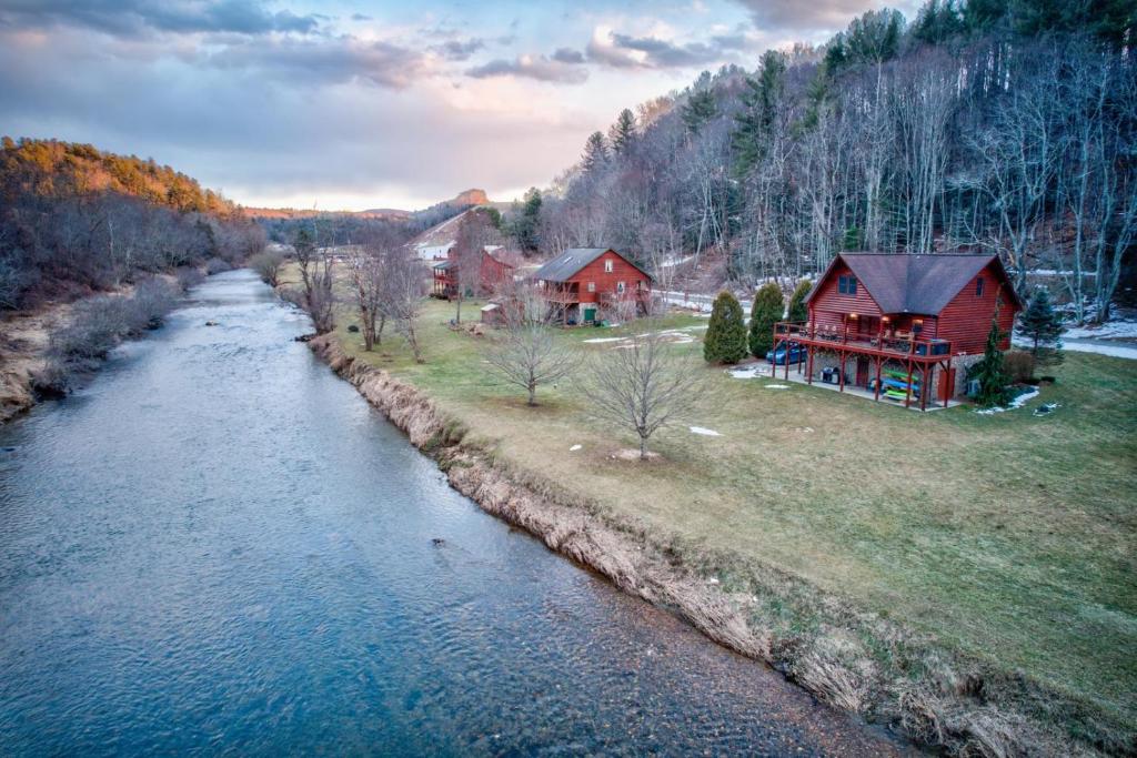an aerial view of a house next to a river at River Roost in Todd