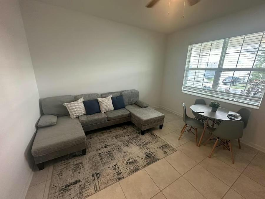a living room with a couch and a table at Cozy apartment near legoland in Eagle Lake