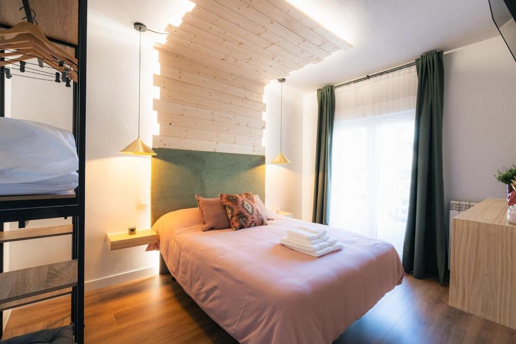 a bedroom with a bed and a window at La Palomilla in Avila