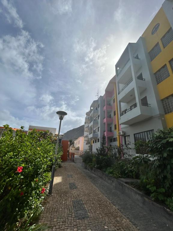 a cobblestone street with buildings and a street light at Apartamento Rua de Horta in Ribeira Grande