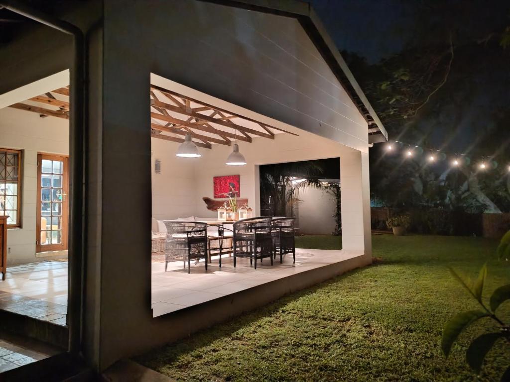 a view of a patio with chairs and a table at 41 South in Mtunzini