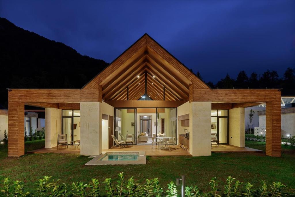 a modern house with a pool at night at Terra Homes in Kolašin