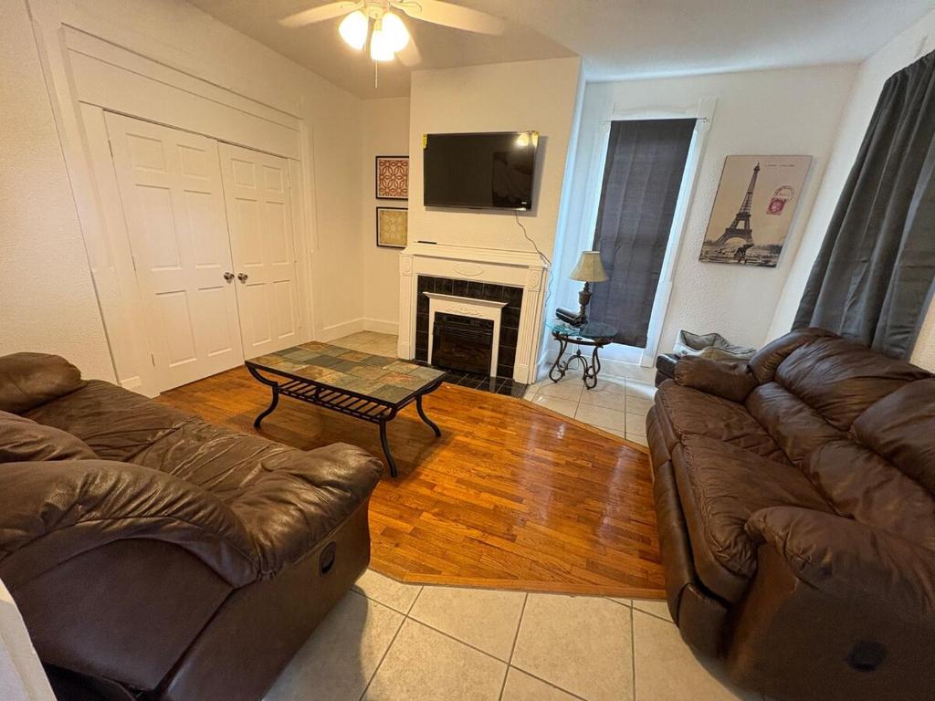 a living room with two couches and a fireplace at 2 Story Home in the Noto Arts District in Topeka