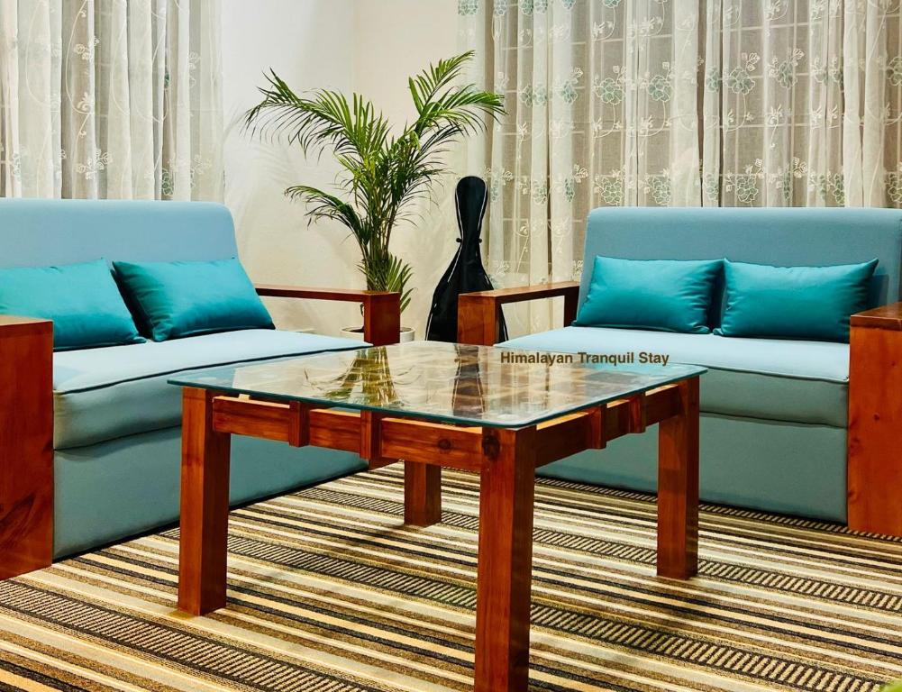 a living room with two couches and a coffee table at Himalayan Tranquil Stay in Burhānilkantha