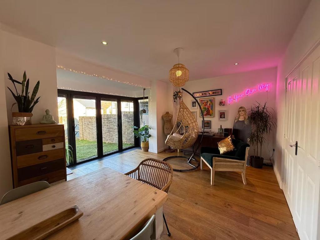 a living room with a table and a desk at West Lodge - Buxton in Buxton